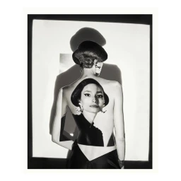 Monochrome portrait of a woman viewed from behind with a portrait projection on her bare back by Lucian Bor