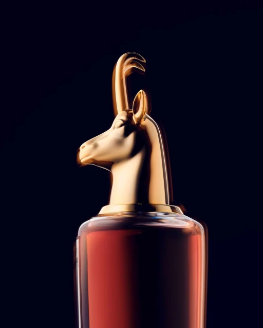 Elegant presentation of a perfume bottle with a golden animal-shaped cap against a dark backdrop, creating a luxurious aesthetic.