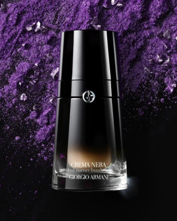 Giorgio Armani Crema Nera foundation bottle set against a textured purple background with metallic highlights.