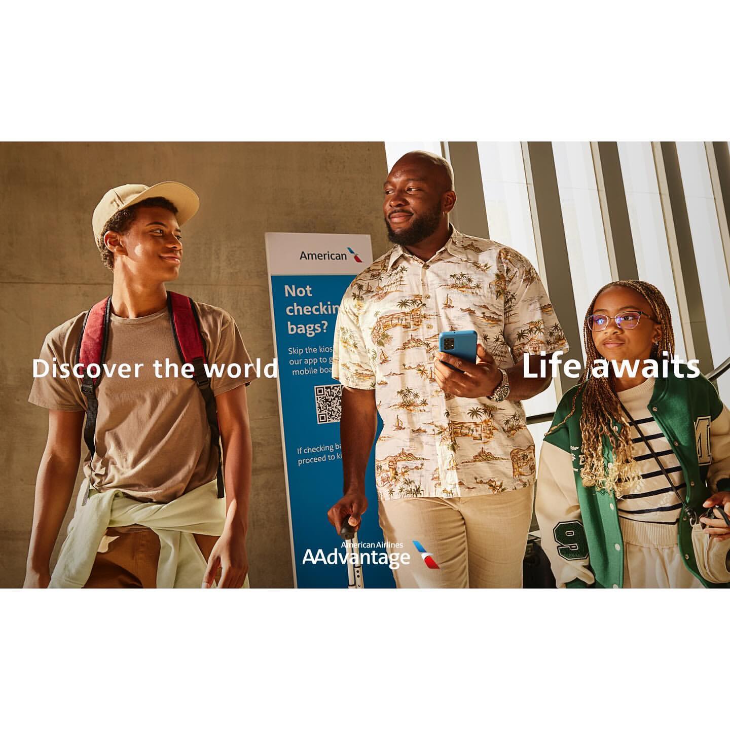 An advertisement featuring three people and an American Airlines sign. The people appear to be in transit, suggesting travel.