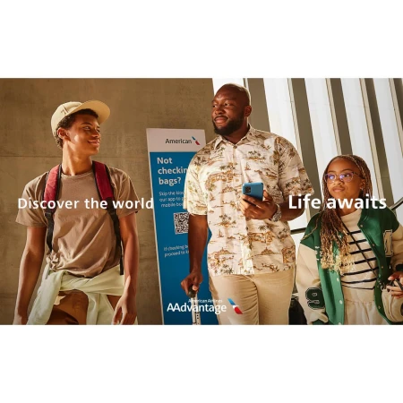 An advertisement featuring three people and an American Airlines sign. The people appear to be in transit, suggesting travel.