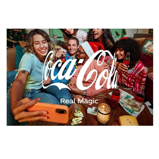 Festive Coca-Cola advertisement featuring a group of smiling adults taking a selfie in a decorated living room with Coca-Cola bottles.