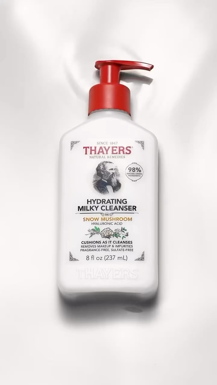 White bottle of Thayers Hydrating Milky Cleanser with red pump on white backdrop. Skincare product shot for beauty and personal care.