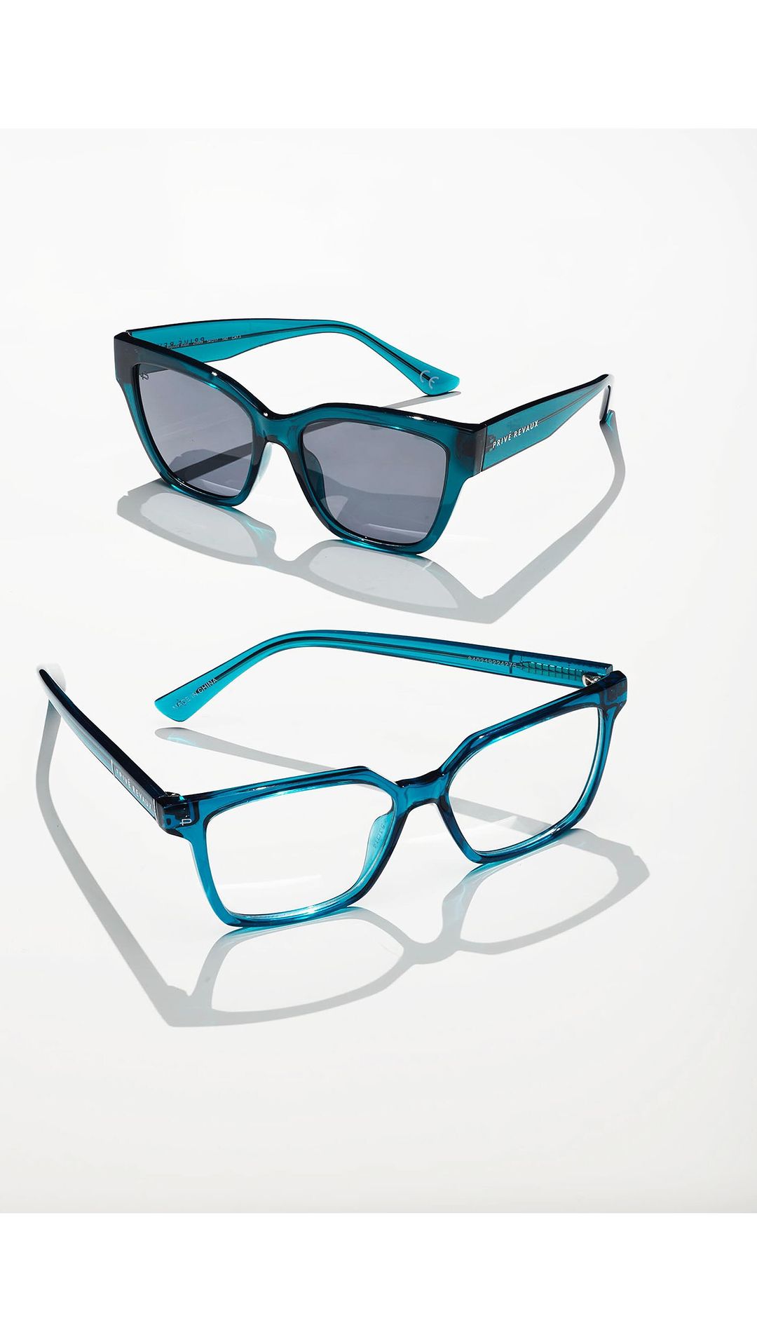 Two pairs of stylish eyeglasses and sunglasses with teal frames are positioned on a white surface, casting distinct shadows.