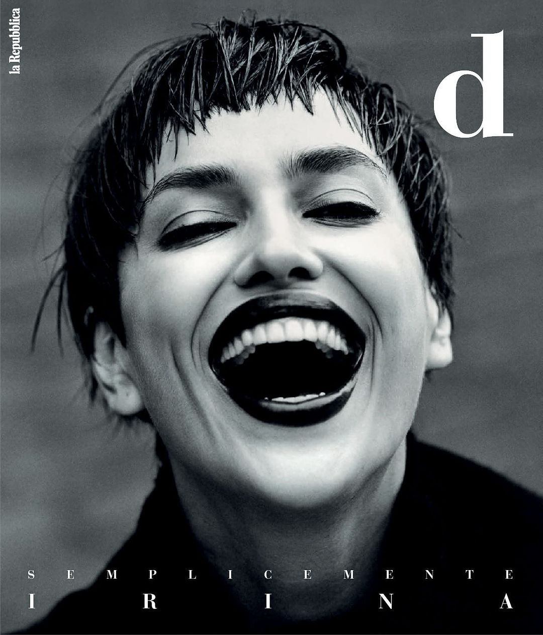 Black and white fashion magazine cover featuring a woman with short dark hair, dark lipstick, laughing with her eyes closed, and the brand logo.