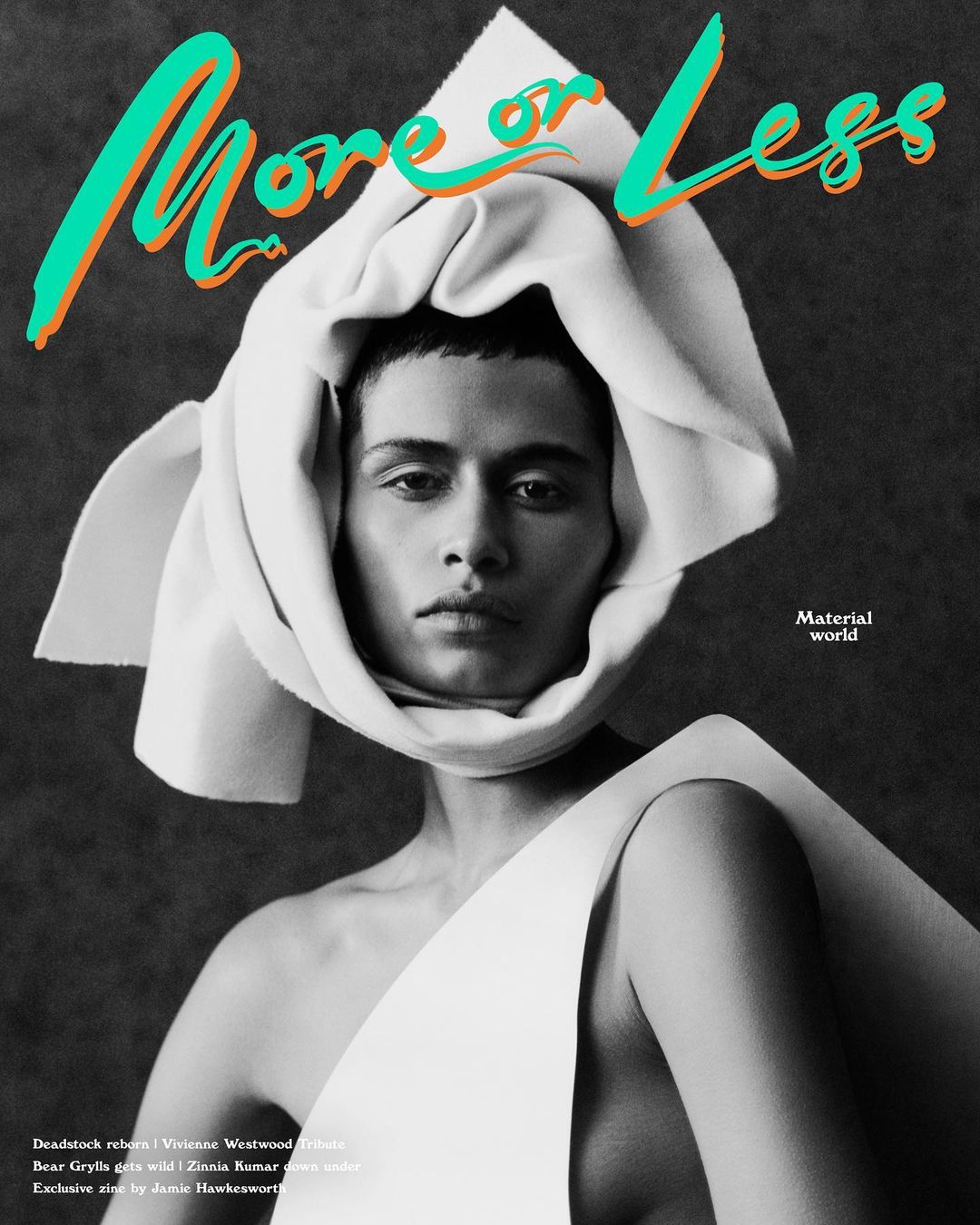 Fashion editorial shot of a person with bare shoulders, head wrapped in white fabric, wearing white clothing, against a grey backdrop.