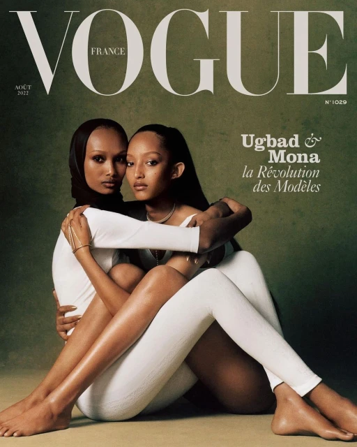 Vogue France cover with two women embracing in white outfits against a textured background, featuring the magazine's masthead and text.