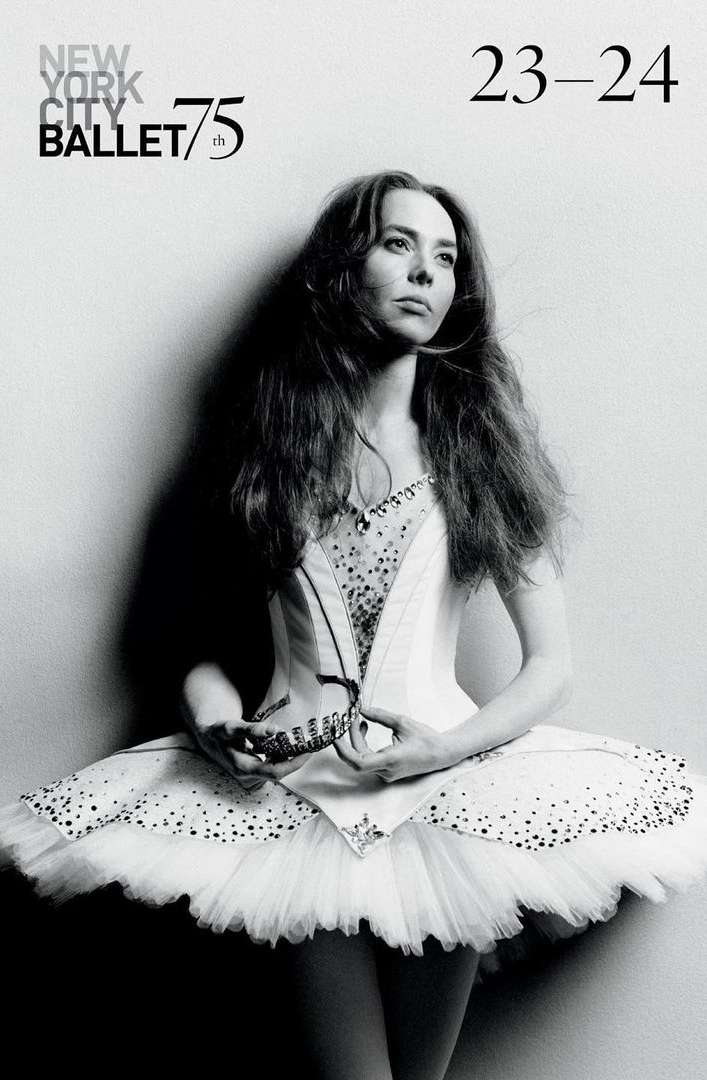 A ballet dancer in a white tutu and bodice poses in front of a wall in a black-and-white portrait, promoting New York City Ballet's 75th season.