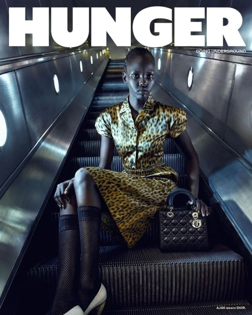 Hunger magazine cover featuring a woman in an animal print dress and black and white heels on an escalator holding a black bag.