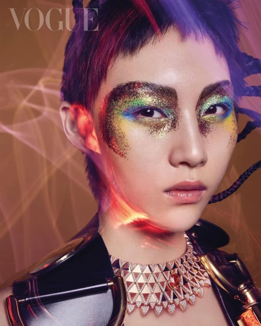 Close-up of an adult Asian woman's face wearing colorful makeup with futuristic jewelry and hairstyle in a beauty fashion editorial shoot.
