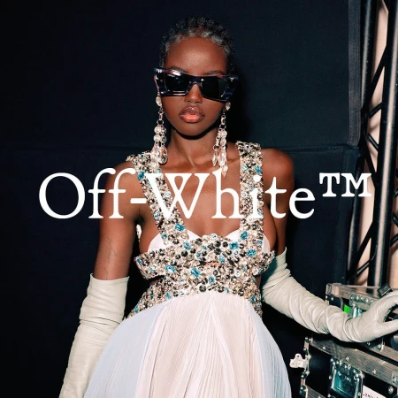 Black woman wearing ornate jeweled dress and long gloves with large crystal earrings and sunglasses by Lukas Wassmann
