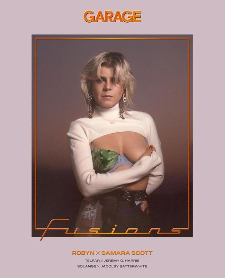 Artistic magazine cover featuring a person with short blonde hair wearing a white top and long earrings in a brown frame.