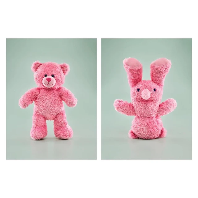 Pink stuffed teddy bear and bunny toy animals against a pale green background. Stuffed toys, children's toys, studio photography.