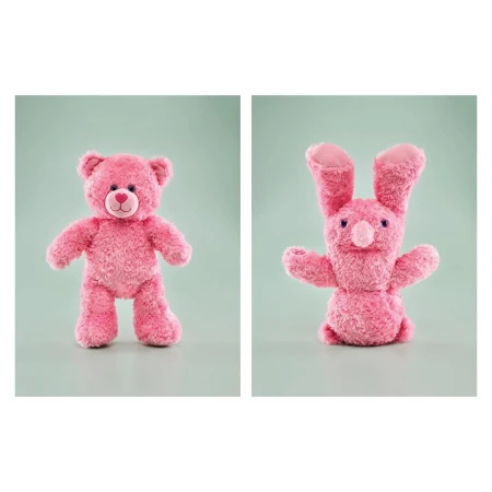 Pink stuffed teddy bear and bunny toy animals against a pale green background. Stuffed toys, children's toys, studio photography.