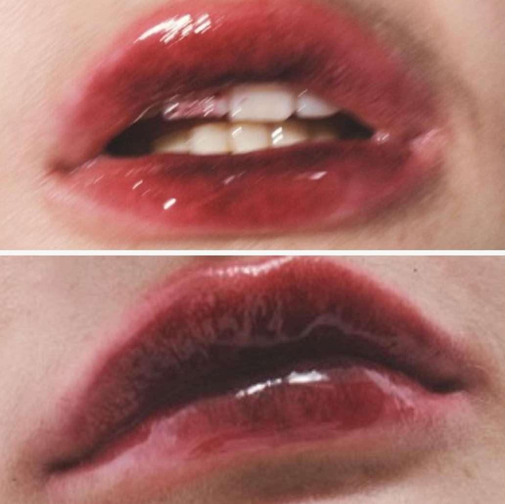 Close-up shot featuring a woman's red glossy lips and white teeth, emphasizing the beauty and detail of the makeup and features.