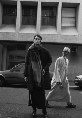 Monochrome street portrait of a woman in a heavy coat and scarf standing in Cape Town by Luke Kuisis.