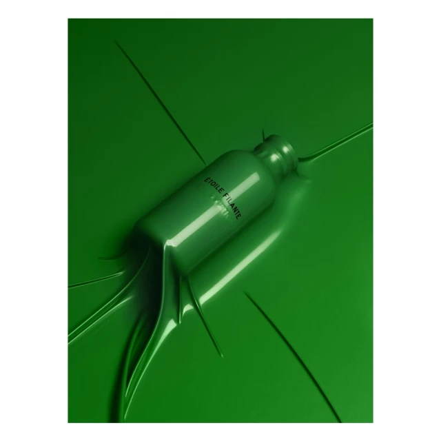 Elevated view of a glossy green cosmetic bottle on matching surface, partially submerged in glossy liquid, studio lighting, beauty aesthetic.