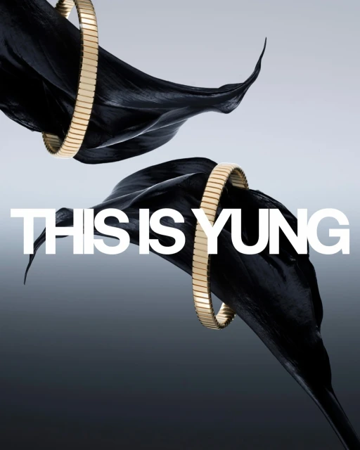 Elevated product shot of golden bracelets adorning black calla lilies against a soft gradient background, showcasing luxury and elegance.