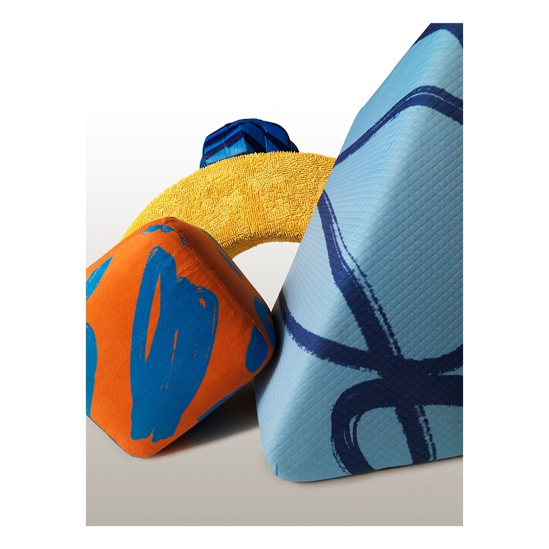 Abstract still life of colorful geometric foam shapes with brushstroke patterns against a white background, creating a modern composition.