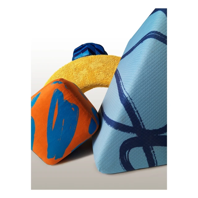 Abstract still life of colorful geometric foam shapes with brushstroke patterns against a white background, creating a modern composition.