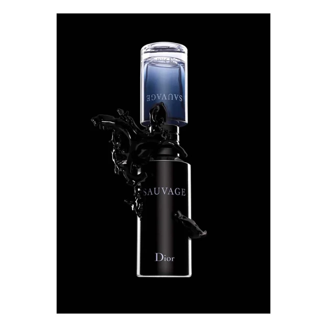 Crystal clear bottle of Sauvage Dior cologne with liquid splash, studio shot on black backdrop, creating an elegant and luxury vibe.