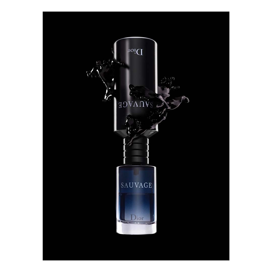 Dior Sauvage perfume bottle set against a black background with liquid splashes around it, product shot for beauty and fashion.