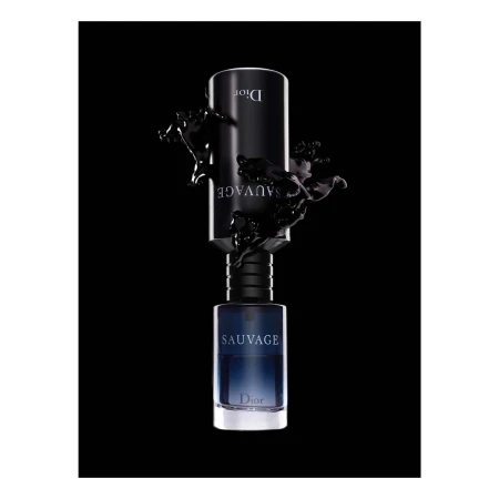 Dior Sauvage perfume bottle set against a black background with liquid splashes around it, product shot for beauty and fashion.