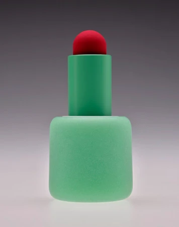 Minimalist studio shot of a geometric plastic sculpture in hues of green and red, set against a gradient gray background.