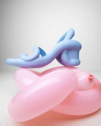 A light blue high-heeled shoe resting on top of twisted pink glossy balloons against a white studio background.
