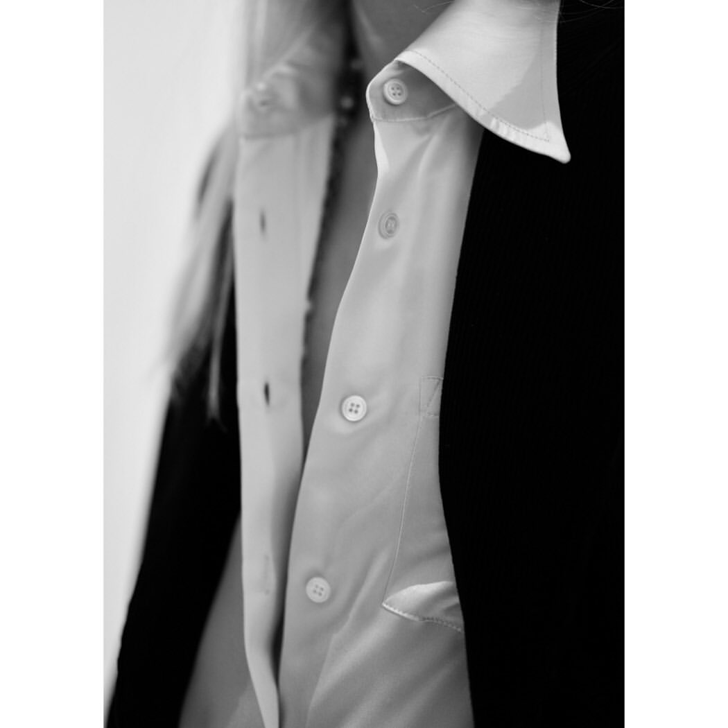 Close-up portrait of a person wearing a white button-down shirt and a dark jacket by photographer Lynette Garland