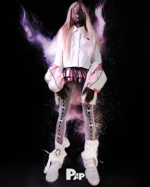 Fashion-forward portrait of a Black adult woman with blonde hair, styled in a white and pink outfit against a dark backdrop with smoke.