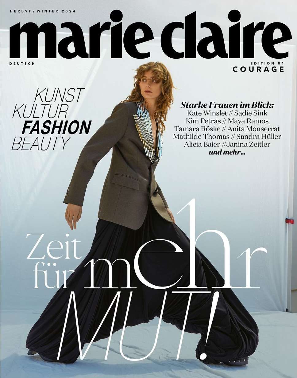 Marie Claire magazine cover featuring a female model in a blazer and wide-leg pants against a light background with prominent text.
