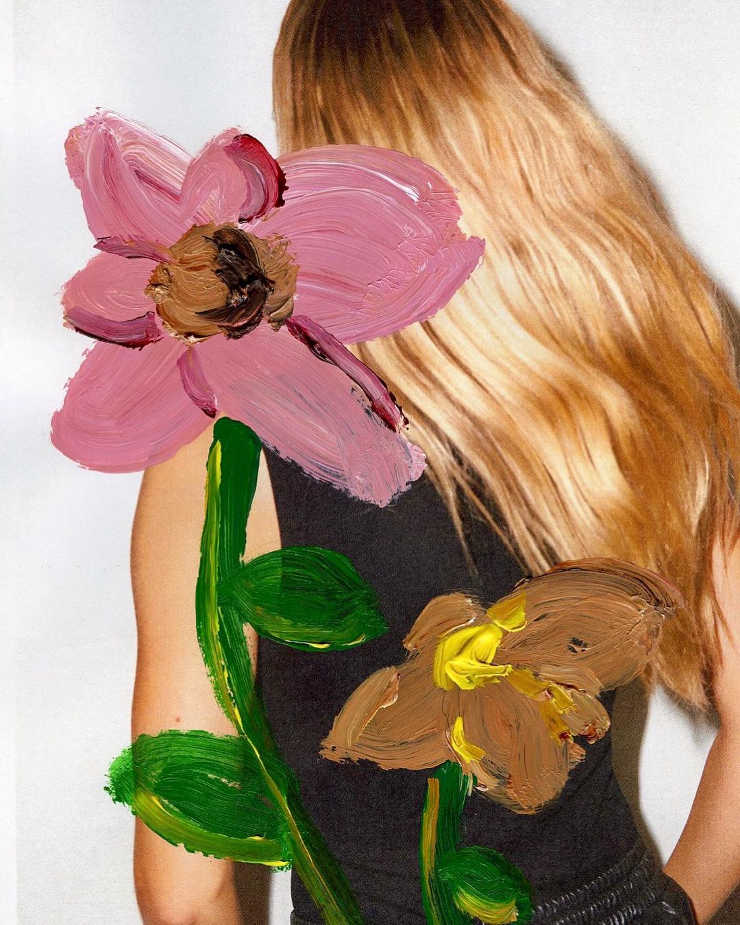 Blonde woman with black top and painted flower art. Soft light illuminates the person and the floral elements in studio shot.