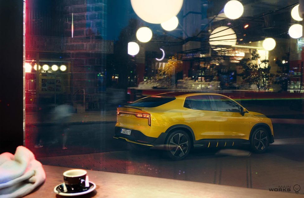 Yellow electric SUV parked on a city street at night, reflected in a window with a coffee cup on a table inside.