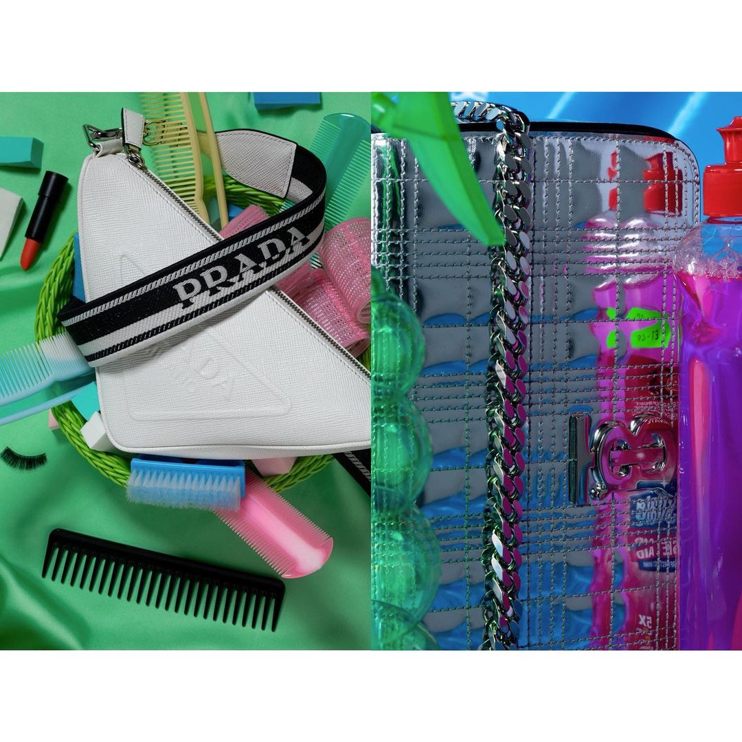 Still life of two designer handbags, makeup, and hair accessories against a bright backdrop, creating a vibrant and colorful composition.