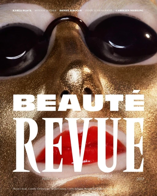 Close-up of a model's face with gold-colored makeup and large black sunglasses, featuring text overlay for 'Beauté Revue'.