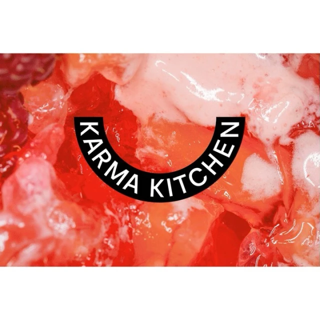 Close-up of a vibrant, colorful food preparation, featuring a bright red and white color scheme, and the text 'Karma Kitchen'.