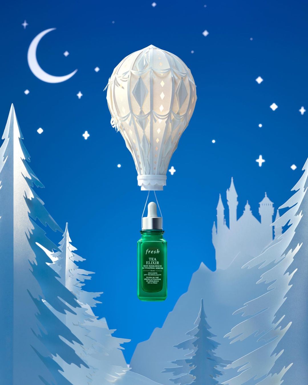 Creative product shot for fresh Tea Elixir serum, showcasing a paper hot air balloon over paper winter landscape against blue starry night.