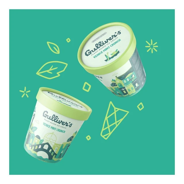 Two floating containers of Gulliver's Venice Mint Crunch plant-based ice cream on a vibrant green background with abstract shapes.