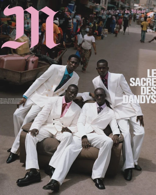 Editorial fashion shot: four black men in white suits pose on a couch in a busy urban street for magazine cover. Magazine graphic on top.