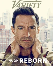 Portrait of Hugh Jackman with hands behind neck against an urban background, photographed by Marc Hom for Variety magazine