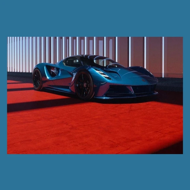 Sleek, blue sportscar with black wheels parked on a red carpet in front of a modern architectural backdrop with white columns.