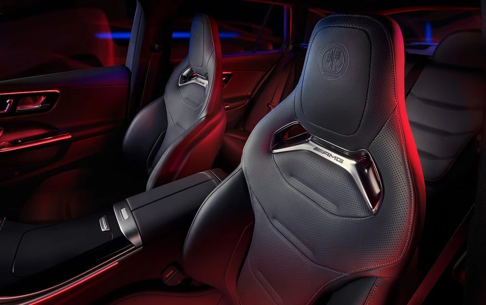 Automotive interior view featuring black leather seats with metallic accents in a luxury car with red and blue ambient lighting.
