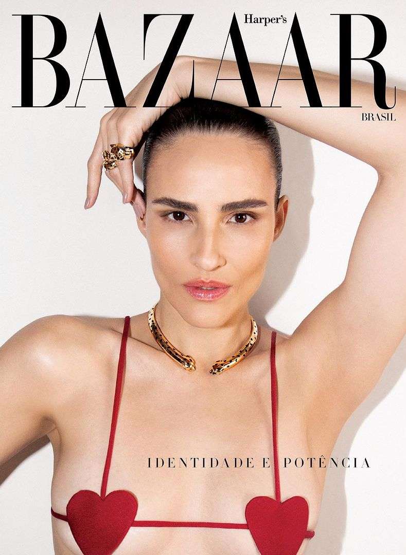 Harper's Bazaar cover featuring a tanned woman in a red heart-shaped top and gold snake necklace, striking a pose against a plain white backdrop.