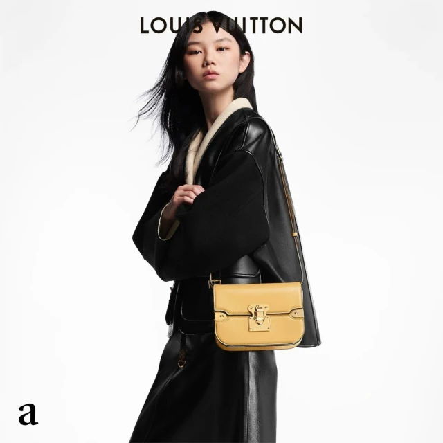 A stylish Asian woman in a black leather coat poses with a yellow leather handbag in a fashion studio shot against a white backdrop.