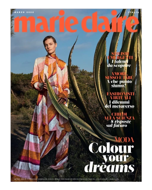 Marie Claire Italia magazine cover featuring a woman in a patterned outfit, posing near a large agave plant under a bright sky.