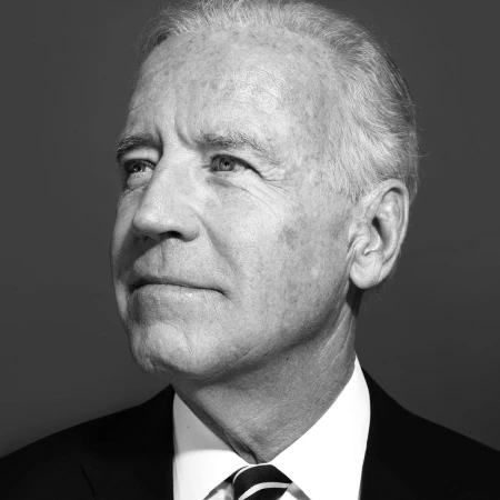 Black and white portrait of Joe Biden looking upward, wearing a dark suit, white collared shirt, and striped tie.