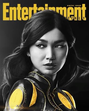Close-up portrait of Gemma Chan on the cover of Entertainment Weekly. She is in black and gold attire against a dark background.