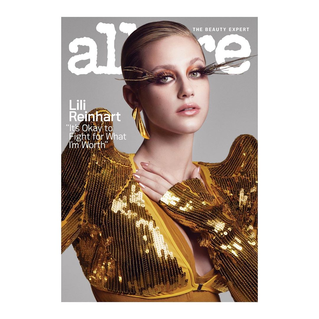 Lili Reinhart on the cover of Allure magazine, wearing a gold sequined top with exaggerated shoulder pads and large gold earrings.