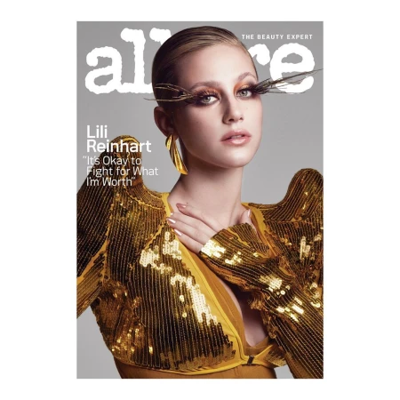 Lili Reinhart on the cover of Allure magazine, wearing a gold sequined top with exaggerated shoulder pads and large gold earrings.